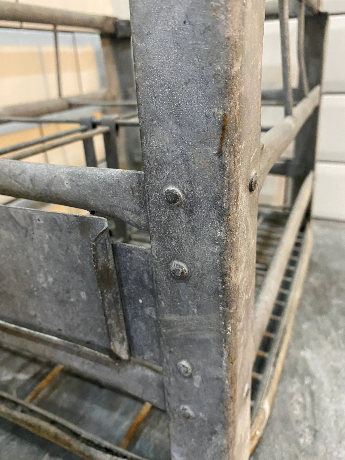 Close-up of vintage metal storage rack with rivets and aged patina in industrial style