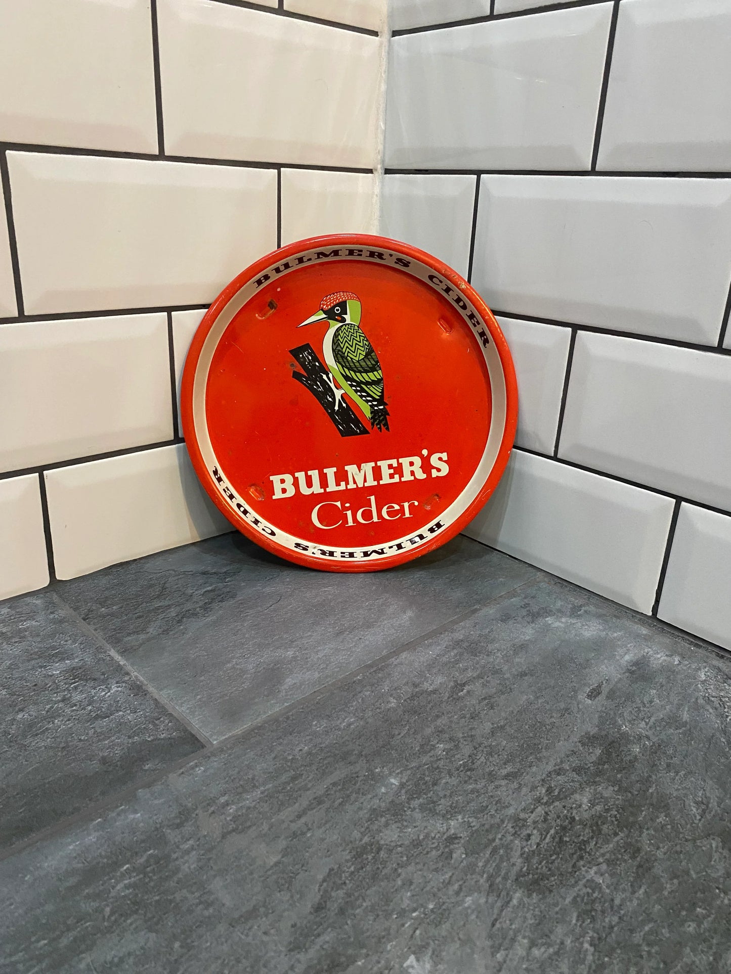 Vintage Bulmer's Cider tray with bird illustration on tiled kitchen surface