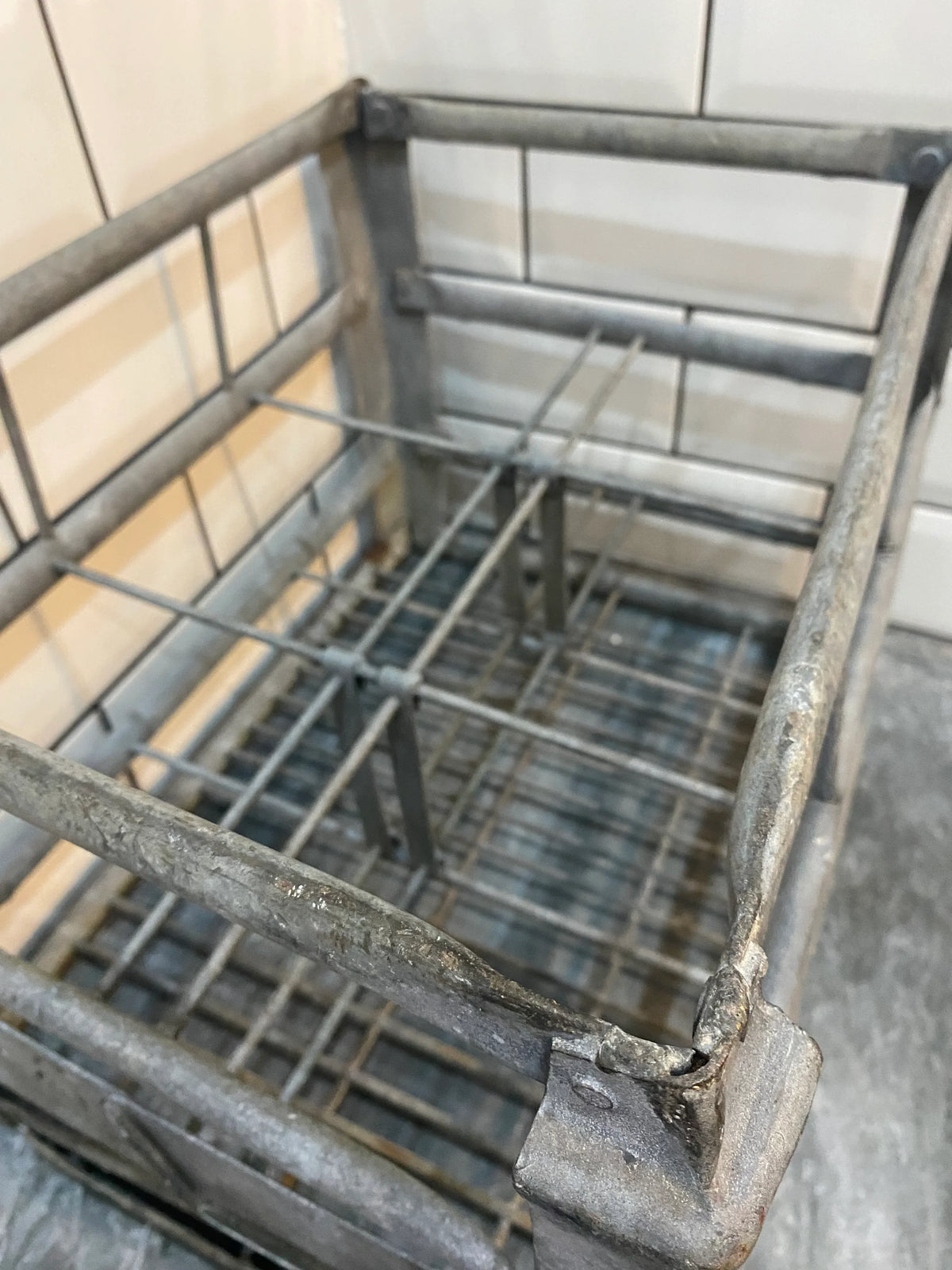 Vintage metal storage crate with grid design, rustic industrial decor