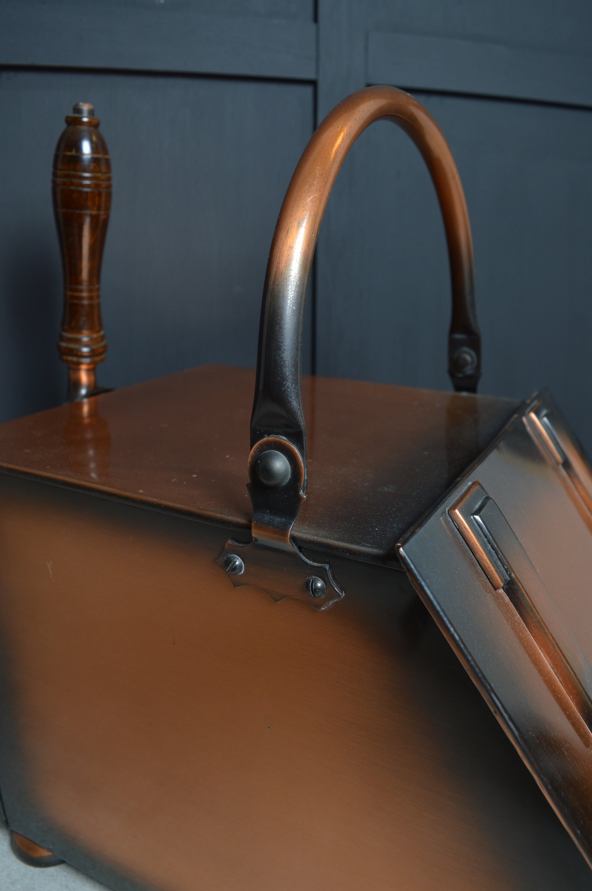 Antique copper coal scuttle with wooden handle and hinged lid for fireplace decor