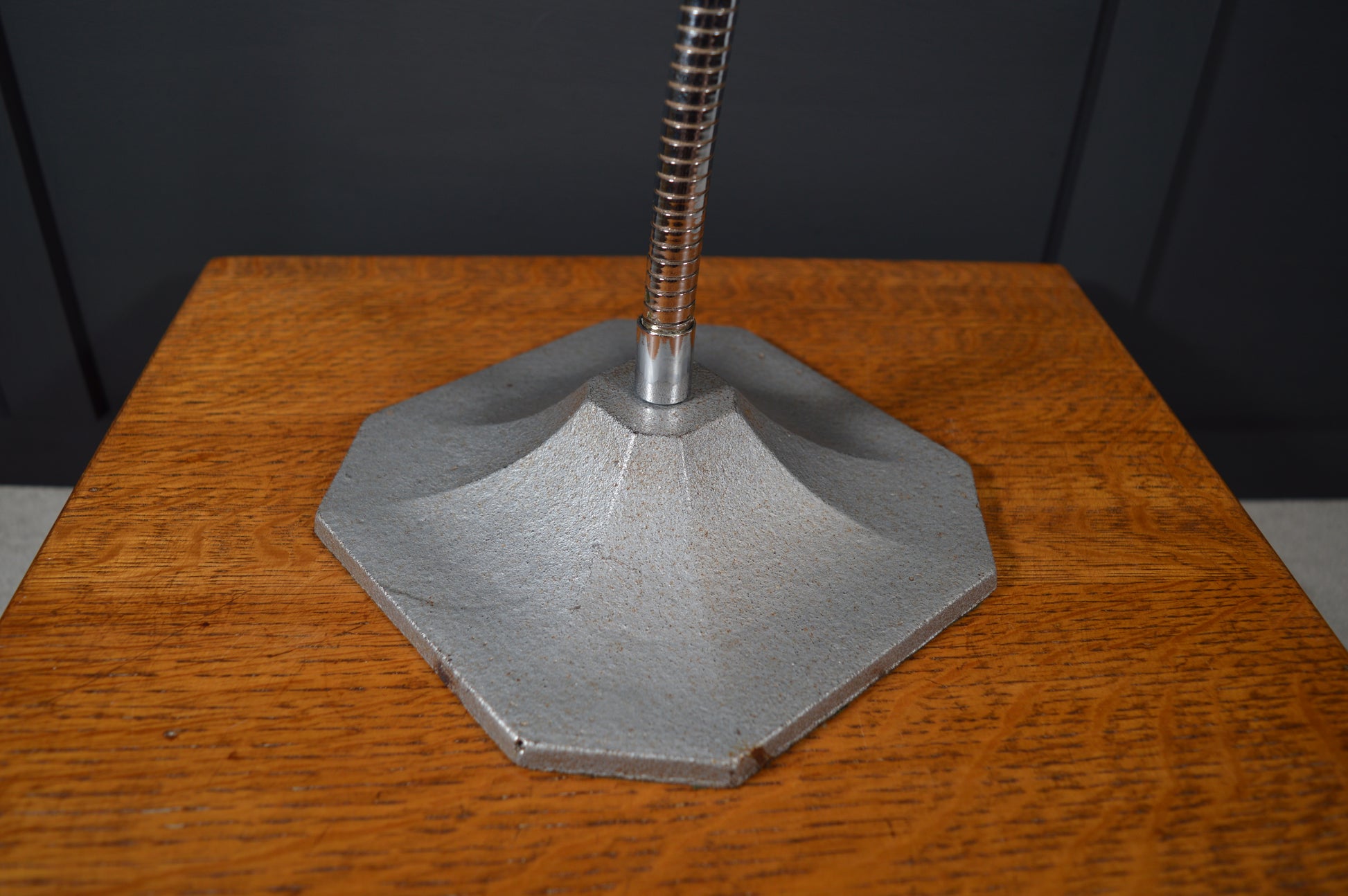 Vintage industrial lamp base with geometric metal design on wooden surface