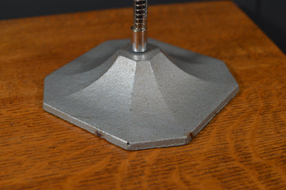 Hexagonal metal lamp base with industrial finish on wood surface